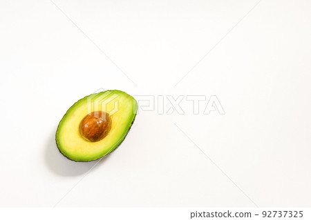 Avocado halves on a white background for healthy nutrition Avocado halves on a white background for healthy nutrition 92737325
