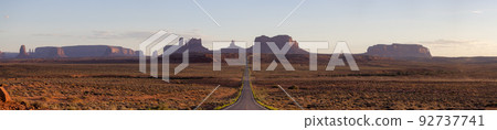 Scenic Road in the Dry Desert with Red Rocky Mountains in Background. 92737741