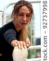 Shot of young sporty woman wearing sportwaer doing stretching exercise. 92737998