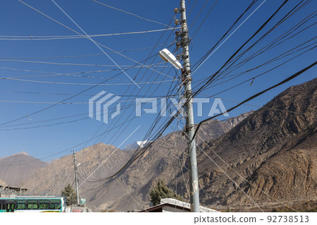 Street lamps on the streets of the town of Jomsom. Wires and electric lantern against the backdrop of mountains. Himalayas, Nepal 92738513