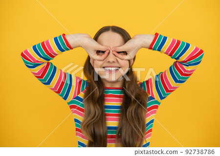 Beautiful teenager child girl look finger specs okey symbol  92738786