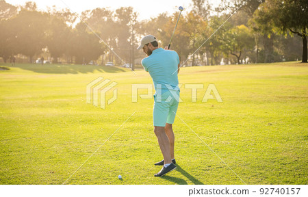 back view of male golf player on professional course with green grass, recreation 92740157