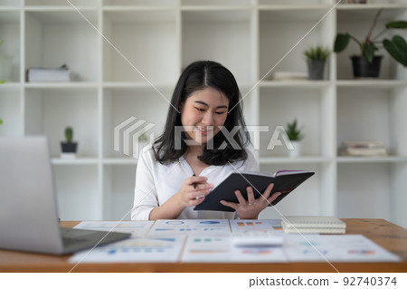 Business asian female working on laptop conputer at home office. 92740374