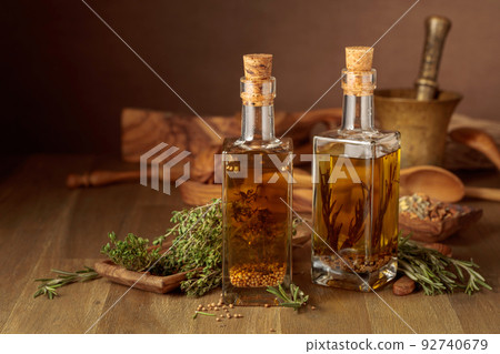Bottles of olive oil with herbs and spices. Bottles of olive oil with herbs and spices. 92740679