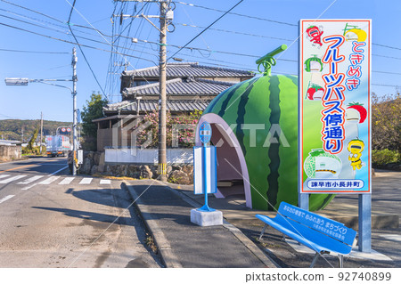 [Kyushu/Isahaya] Signboard and watermelon on the famous Tokimeki Fruit bus stop street on the road in Konagai town. 92740899