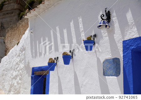 White house wall with potted flowers White house wall with potted flowers 92741065