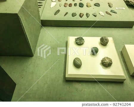 ancient stones on display. Museum piece. minerals of the ancient world. finds of ancestors in caves. stones for building houses and creating sculptures and decorations ancient stones on display. Museum piece. minerals of the ancient world. finds of ancestors in caves. stones for building houses and creating sculptures and decorations 92741204