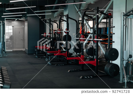 Heavy Weight Lifting Equipment Standing In A Row In Empty Gym, Heavy Weight Lifting Equipment Standing In A Row In Empty Gym, 92741728