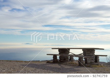 Horizon landscape with clouds and bench in foreground Horizon landscape with clouds and bench in foreground 92741759