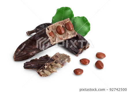 Ripe carob pods and bean isolated on white background with full depth of field Ripe carob pods and bean isolated on white background with full depth of field 92742500