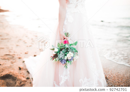 Bride holding big and beautiful wedding bouquet with flowers 92742701