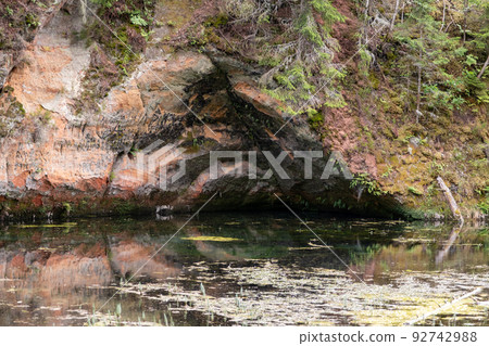 Mirror cliffs and an old river channel in a very beautiful forest in Cirulu nature trails, Latvia. Mirror cliffs and an old river channel in a very beautiful forest in Cirulu nature trails, Latvia. 92742988