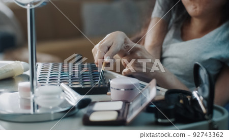 Woman with a physical disability using eyeliner Woman with a physical disability using eyeliner 92743362