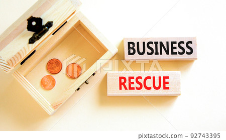 Business rescue symbol. Concept words Business rescue on wooden blocks on a beautiful white table white background. Wooden chest with coins. Business rescue and support concept. Copy space. Business rescue symbol. Concept words Business rescue on wooden blocks on a beautiful white table white background. Wooden chest with coins. Business rescue and support concept. Copy space. 92743395