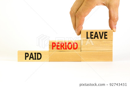 Paid period leave symbol. Concept words Paid period leave on wooden blocks. Beautiful white table white background. Doctor hand. Business medical paid period leave concept. Copy space. 92743431