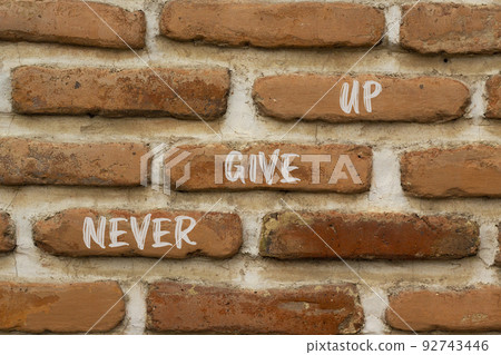 Never give up and support symbol. Concept words Never give up on brick wall. Beautiful brick wall background. Business and never give up quote concept. Copy space. Never give up and support symbol. Concept words Never give up on brick wall. Beautiful brick wall background. Business and never give up quote concept. Copy space. 92743446