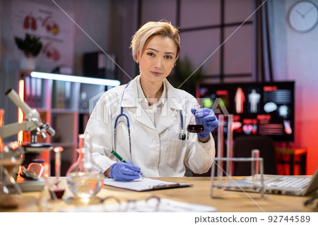 Female scientist working in modern lab. Doctor making microbiology research. 92744589