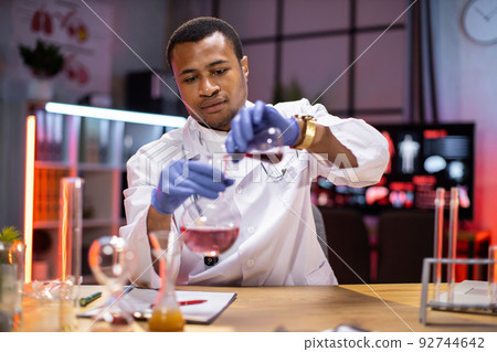 Experienced male scientist in health industry doing analysis of substance. Experienced male scientist in health industry doing analysis of substance. 92744642