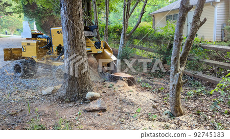 stump grinding machine hard at work 92745183