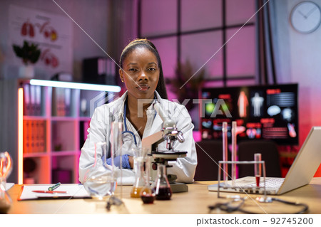 Chemist researcher in sterile lab doing experiments for medical industry using modern technology. Chemist researcher in sterile lab doing experiments for medical industry using modern technology. 92745200