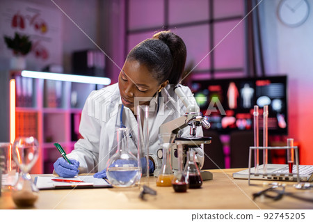 Female african american scientist working in laboratory. Female african american scientist working in laboratory. 92745205