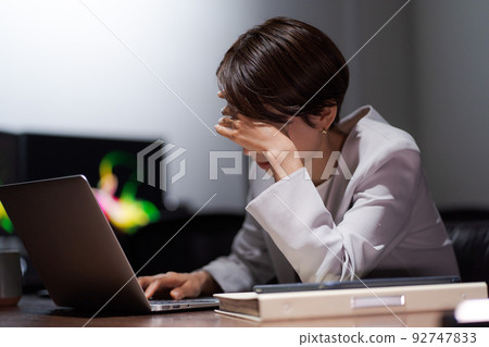 A woman tired from work 92747833