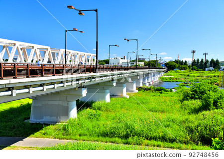 Hino Bridge / Downstream of the Tama River / Looking towards Shibasaki Gymnasium Station and Tachikawa Station from the Hino City side (Hino City, Tokyo) [July 2022] 92748456