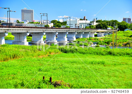 Hino Bridge / Downstream of the Tama River / Looking towards Shibasaki Gymnasium Station and Tachikawa Station from the Hino City side (Hino City, Tokyo) [July 2022] 92748459
