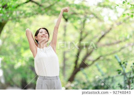 Woman stretching deep breathing exercise fresh green Woman stretching deep breathing exercise fresh green 92748843