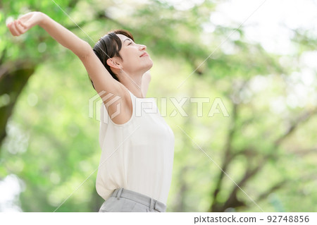 Woman stretching deep breathing exercise fresh green 92748856