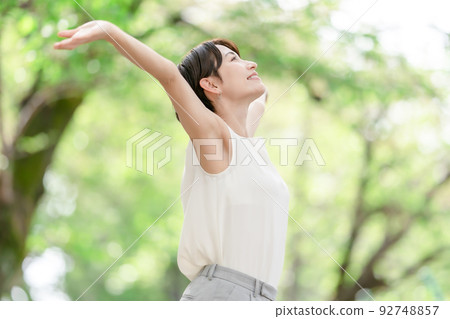 Woman stretching deep breathing exercise fresh green 92748857