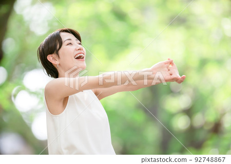Woman stretching deep breathing exercise fresh green 92748867