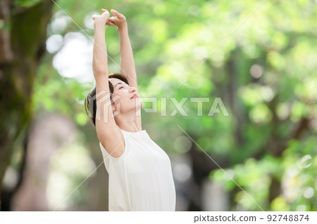 Woman stretching deep breathing exercise fresh green 92748874