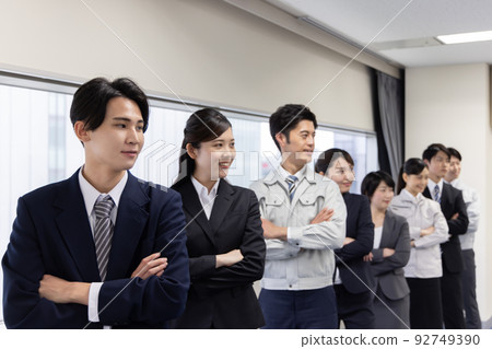 Business people lined up with their arms folded Business people lined up with their arms folded 92749390