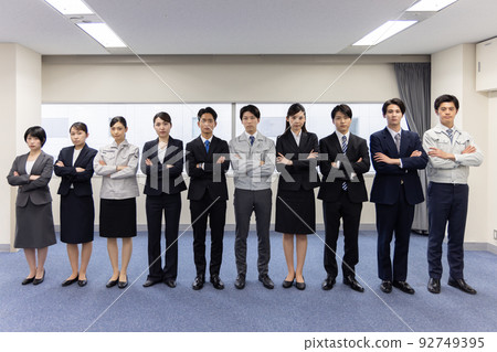 Business people lined up with their arms folded Business people lined up with their arms folded 92749395
