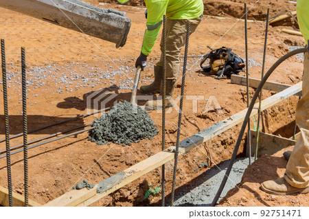 An effective method for constructing houses foundation is to pour concrete trenches along the soil 92751471