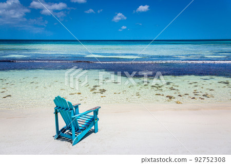 Idyllic beach with rustic adirondack chair in Aruba, Dutch Antilles 92752308