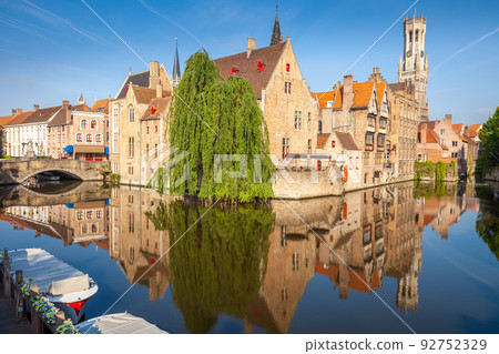 Rozenhoedkaai canal reflection at sunrise and clear sky, Bruges 92752329