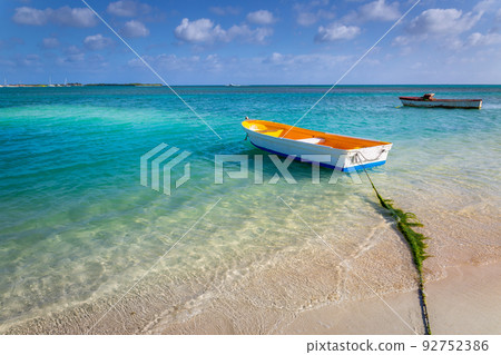 Idyllic beach with rustic wooden fishermen boat in Aruba, Dutch Antilles 92752386