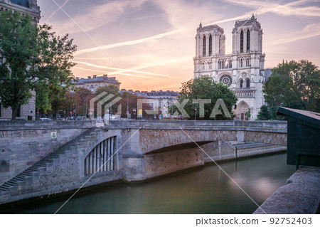 Notre Dame Cathedral of Paris and Seine river at dramatic dawn, France 92752403