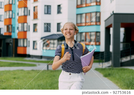 A happy student runs to school, hurries to classes, rejoices in the new academic year. Back to school 92753616