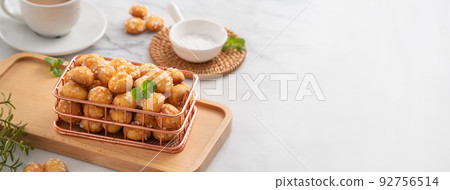 Delicious French Chouquette Choux Pastry dessert Pearl Sugar Puff on white marble background. 92756514
