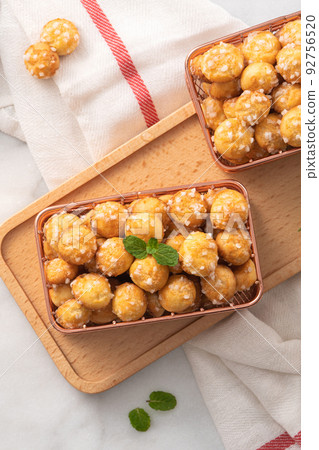 Delicious French Chouquette Choux Pastry dessert Pearl Sugar Puff on white marble background. 92756520
