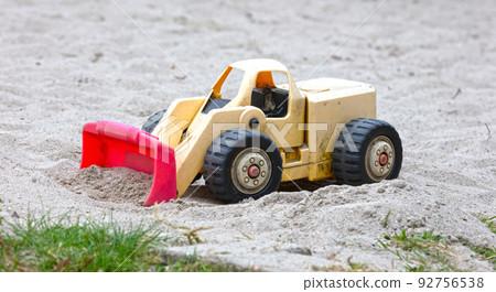 Dump truck toy working on the sand 92756538