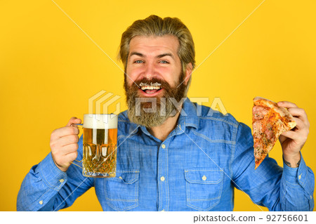 Beer and food. Dinner at pub. Hungry man going to eat pizza and drink beer. Beer and food. Dinner at pub. Hungry man going to eat pizza and drink beer. 92756601