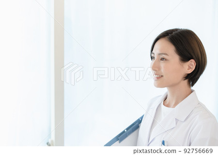A woman in a white coat 92756669