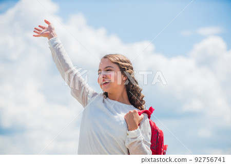 Free education. Happy girl with school backpack sky background. Back to school. Little child smiling going to school. Knowledge day. Outdoors classes. Successful schoolgirl. Good day for studying Free education. Happy girl with school backpack sky background. Back to school. Little child smiling going to school. Knowledge day. Outdoors classes. Successful schoolgirl. Good day for studying 92756741