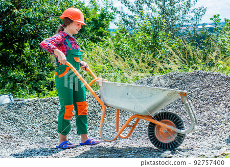 kid wear helmet on construction site. teen girl builder kid wear helmet on construction site. teen girl builder 92757400