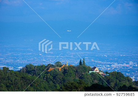 Viewpoint of Phra That Doi Suthep in the morning. Airplane flying over and Chiang Mai city view with lens flare, Chiang Mai, Thailand. 92759685
