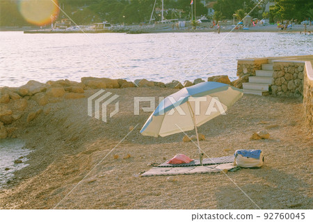 Beach umbrella for relax and comfort on sea coast. Happy summer vacations and resort concept. Sunny day. 92760045